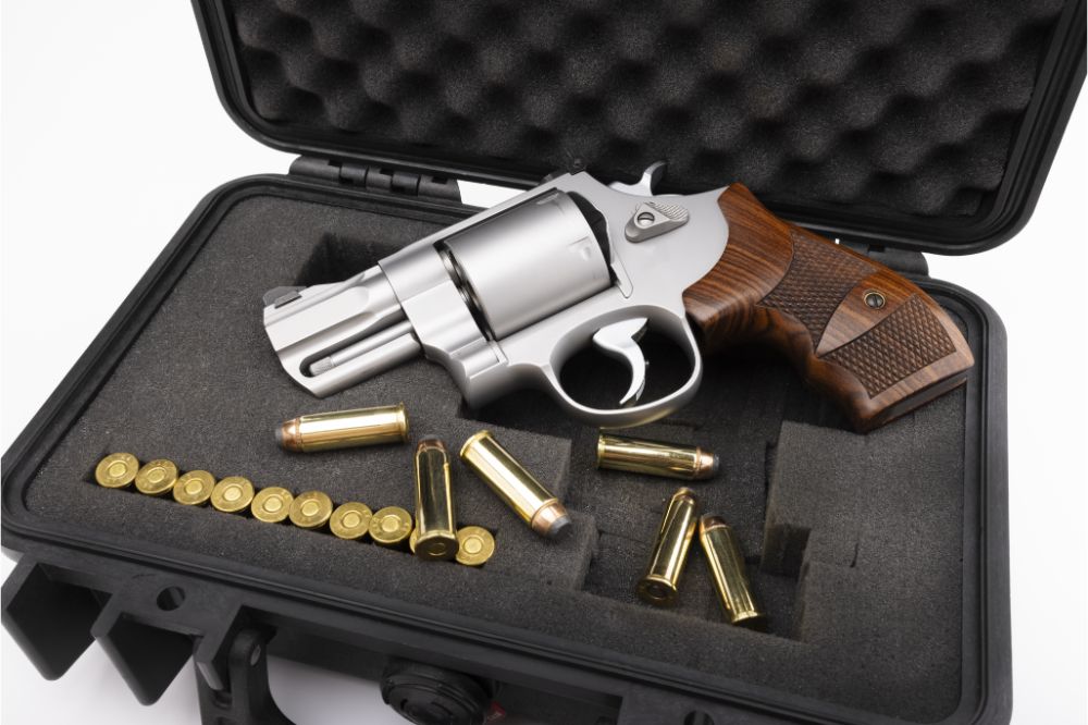 Revolver pistol hand gun and bullets in a plastic hard case